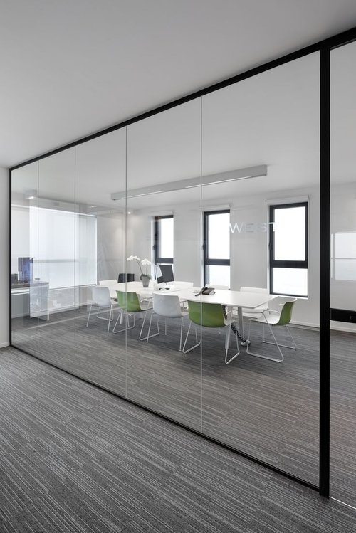 Frameless glass partitions - Modern, open design for flexible room separation.
