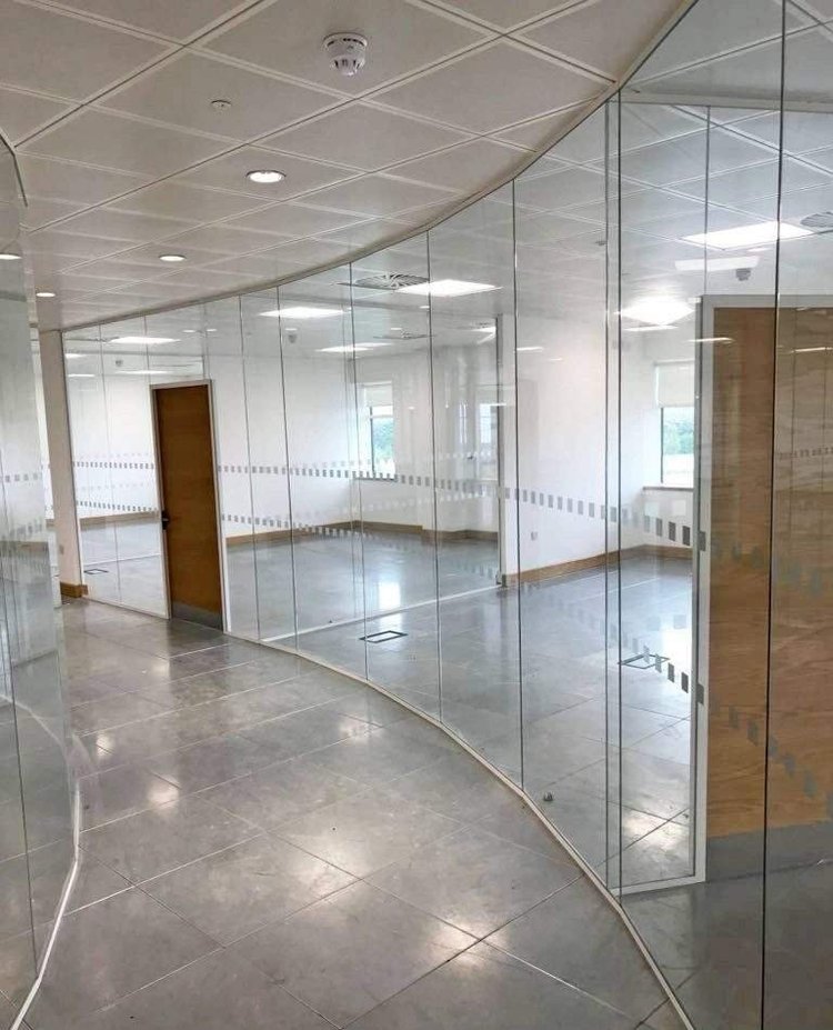 Curved Frameless glass partitions - Sleek and transparent, creating spacious interiors.